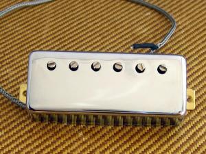 A Guitar Pickup sitting loose on a Tweed Amplifier